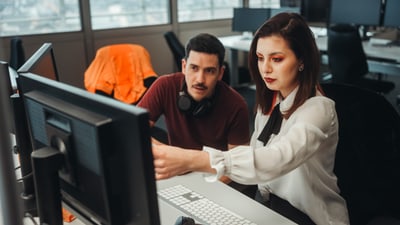 Zwei Personen im Gespräch am Arbeitsplatz