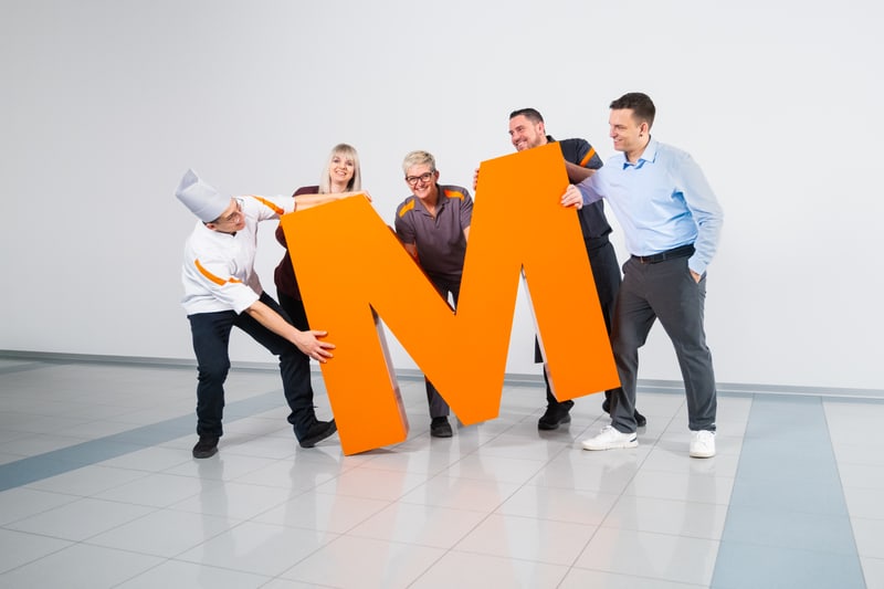 Team der Migros mit dem orangen grossen M