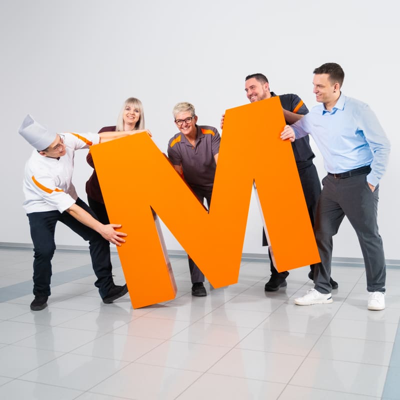 Team der Migros mit dem orangen grossen M